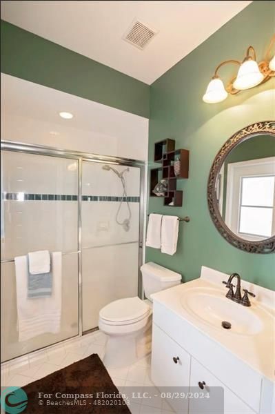12253 Rockledge Circle Boca Raton, FL 33428 - Photo 16 of 22 a bathroom with a sink a toilet and mirror