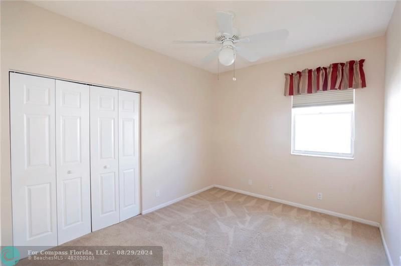 12253 Rockledge Circle Boca Raton, FL 33428 - Photo 17 of 22 an empty room with windows