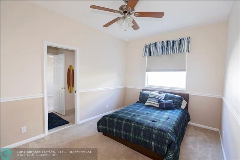 12253 Rockledge Circle Boca Raton, FL 33428 - Photo 19 of 22 a bedroom with a bed and a window