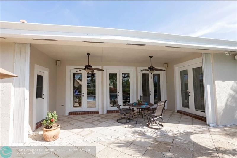 12253 Rockledge Circle Boca Raton, FL 33428 - Photo 21 of 22 a view of a dinning room with chairs and tables in patio