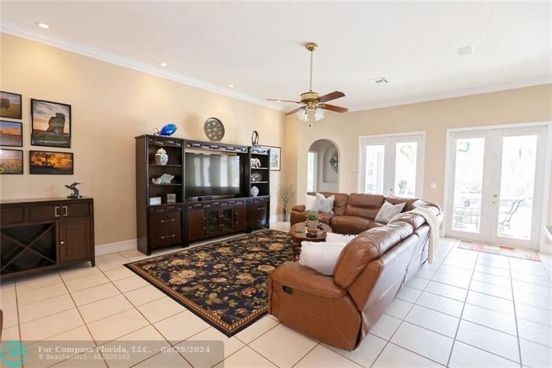 12253 Rockledge Circle Boca Raton, FL 33428 - Photo 6 of 22 a living room with furniture and a chandelier