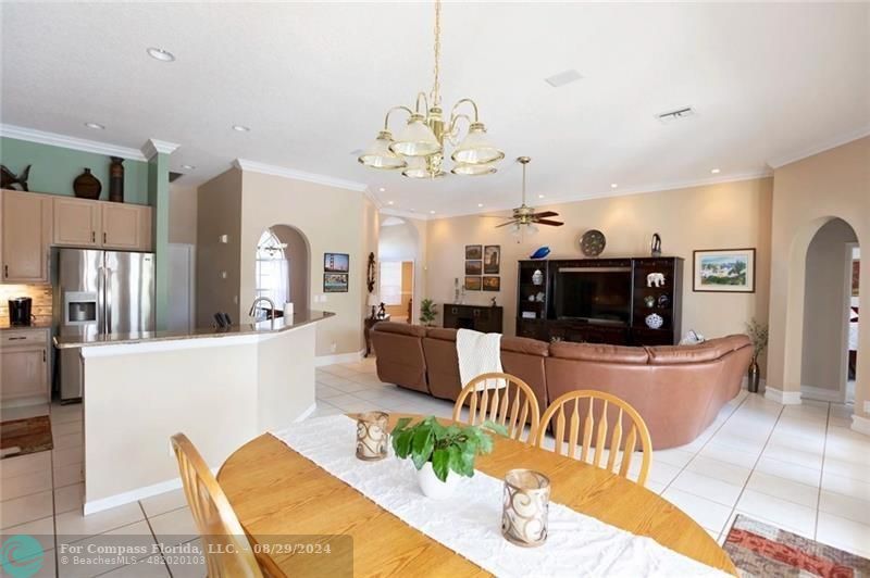12253 Rockledge Circle Boca Raton, FL 33428 - Photo 9 of 22 a living room with furniture a flat screen tv and kitchen view