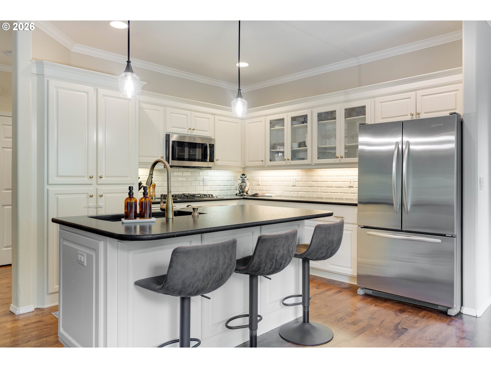 4485 Southwest Joshua Street Tualatin, OR 97062 - Photo 11 of 43 a kitchen with stainless steel appliances granite countertop a sink and a refrigerator