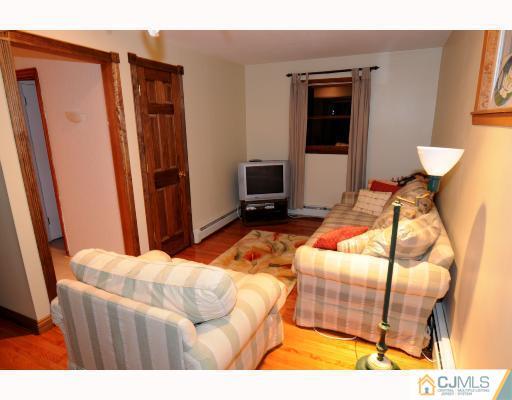192 South Hill Road Colonia, NJ 07067 - Photo 4 of 7 a bedroom with a bed and wooden floor