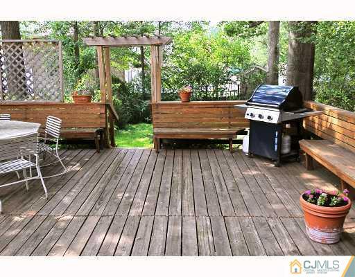 192 South Hill Road Colonia, NJ 07067 - Photo 7 of 7 a backyard of a house with wooden floor outdoor seating and trees