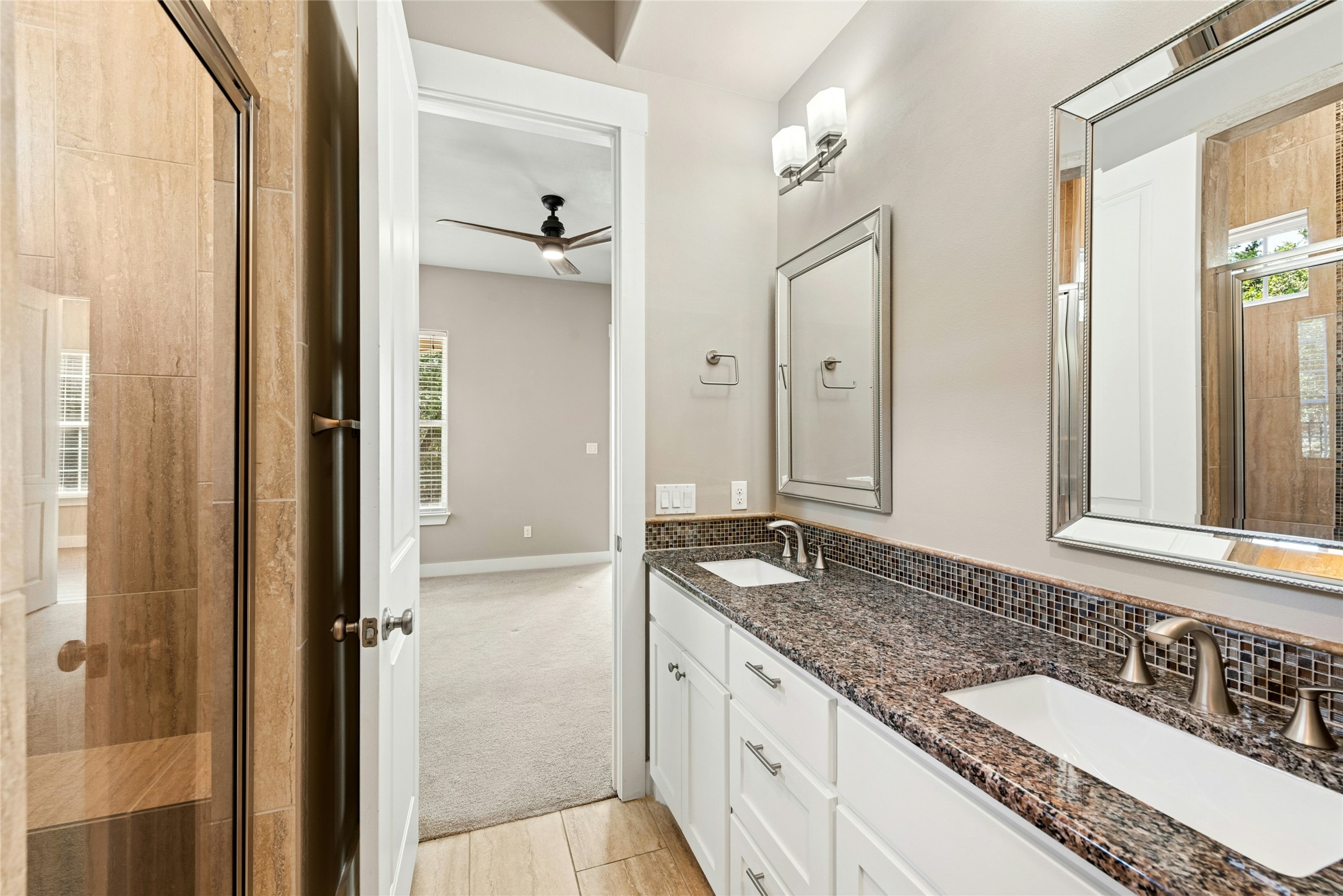 4301 Mansfield Dam Road, Unit 2101 Austin, TX 78734 - Photo 22 of 40 a bathroom with a granite countertop double vanity sink and mirror