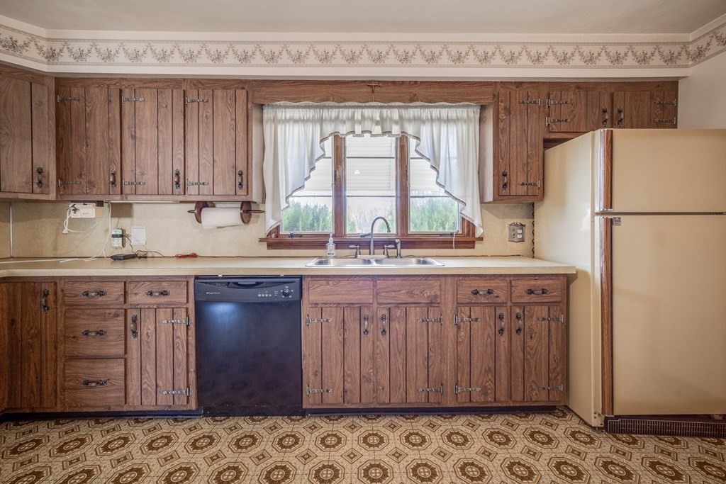 137 Lawrence Road Chicopee, MA 01013 - Photo 12 of 38 a kitchen with stainless steel appliances granite countertop a washer and dryer