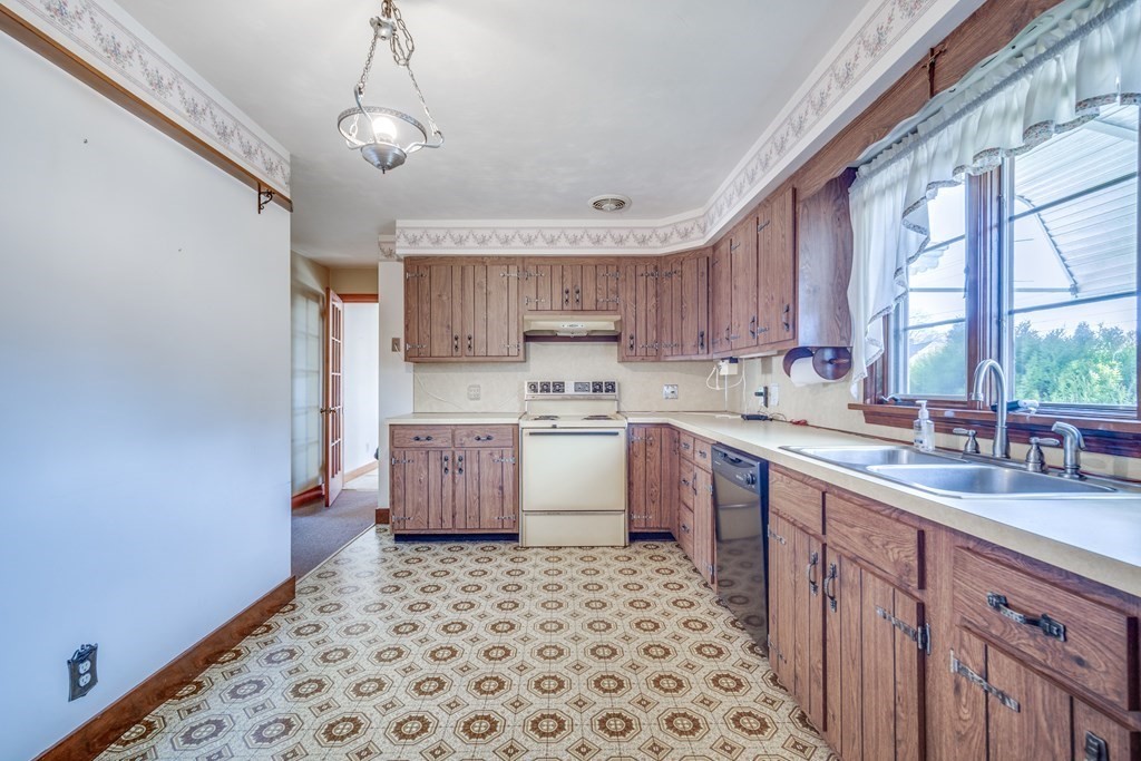 137 Lawrence Road Chicopee, MA 01013 - Photo 13 of 38 a kitchen with a sink window and cabinets