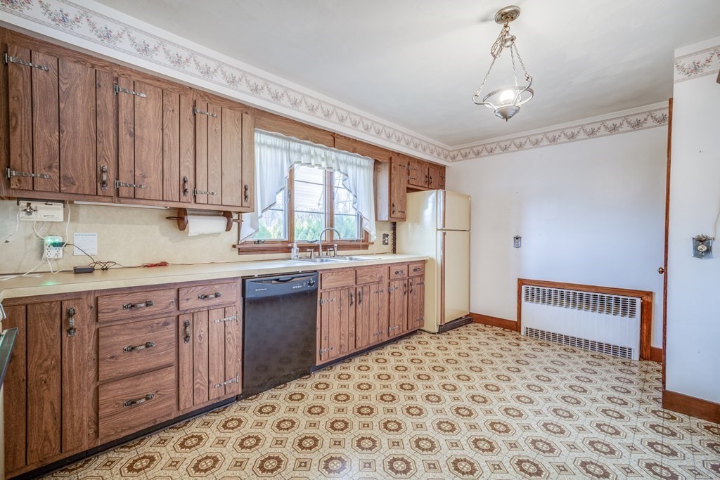 137 Lawrence Road Chicopee, MA 01013 - Photo 14 of 38 a kitchen with a sink window and cabinets