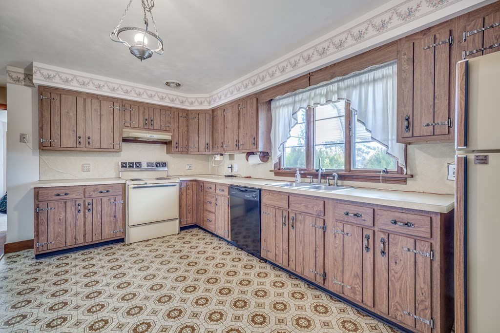 137 Lawrence Road Chicopee, MA 01013 - Photo 15 of 38 a kitchen with a sink window and cabinets