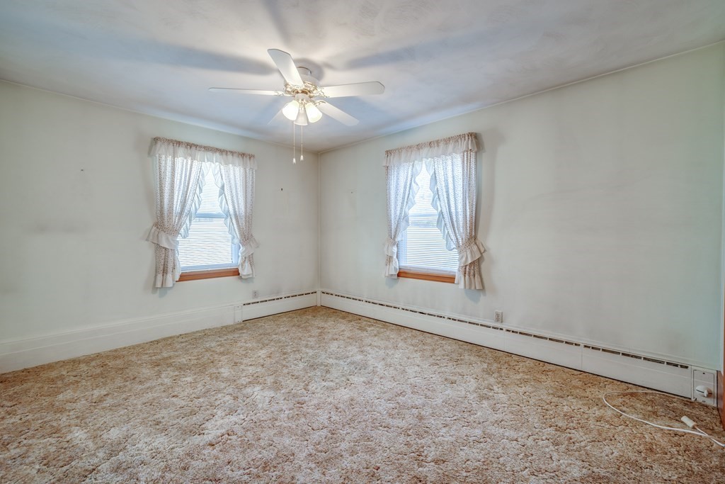 137 Lawrence Road Chicopee, MA 01013 - Photo 25 of 38 an empty room with windows and chandelier fan
