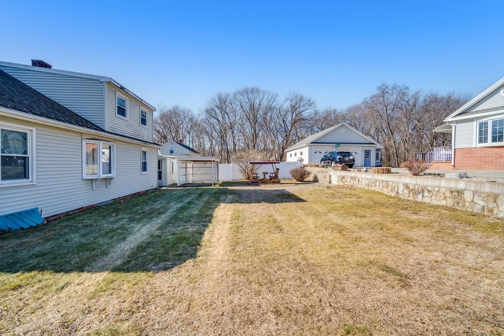 137 Lawrence Road Chicopee, MA 01013 - Photo 10 of 38 a front view of a house with a yard and garage