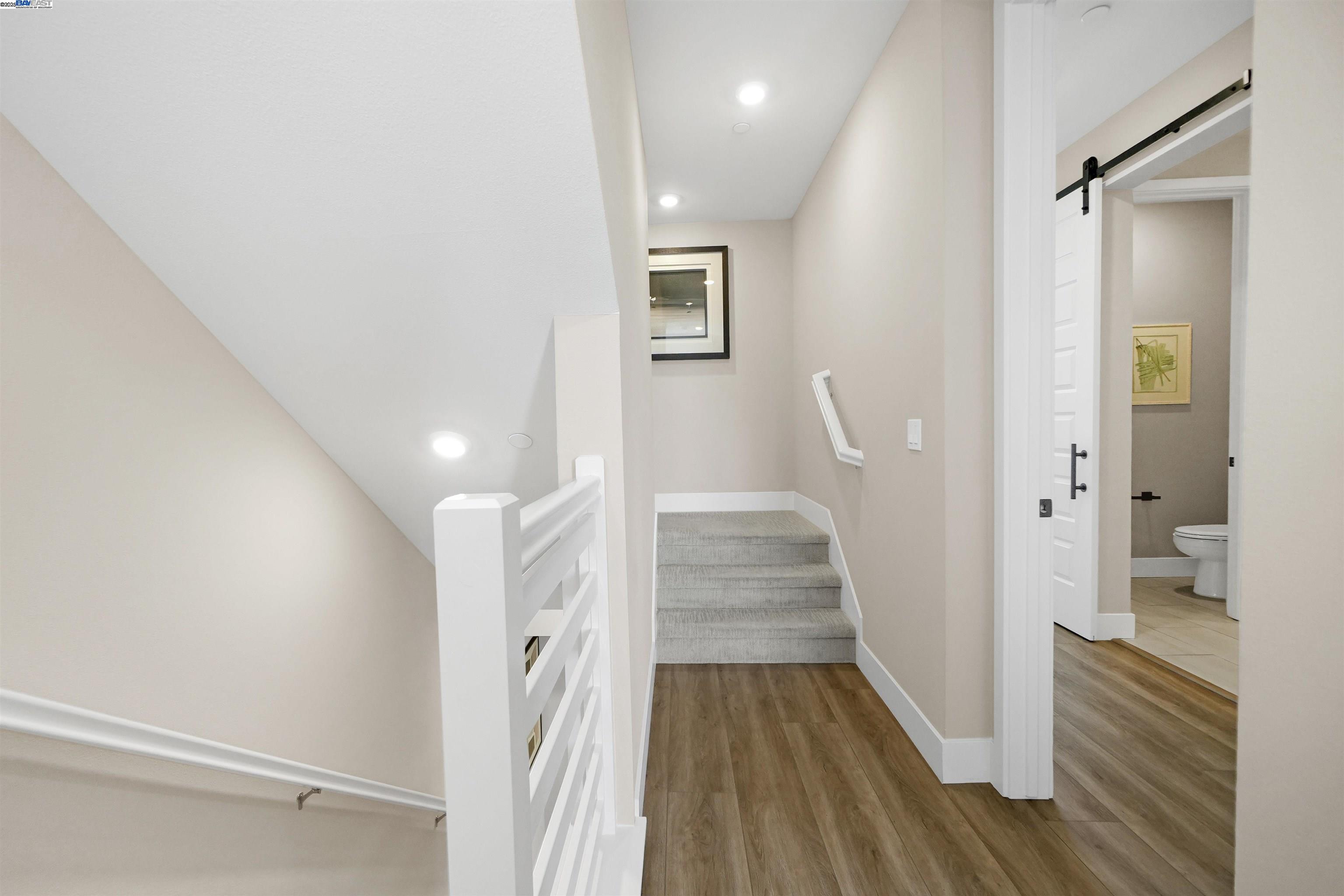 2256 Stanford Street Alameda, CA 94501 - Photo 32 of 60 a view of a hallway with wooden floor and staircase