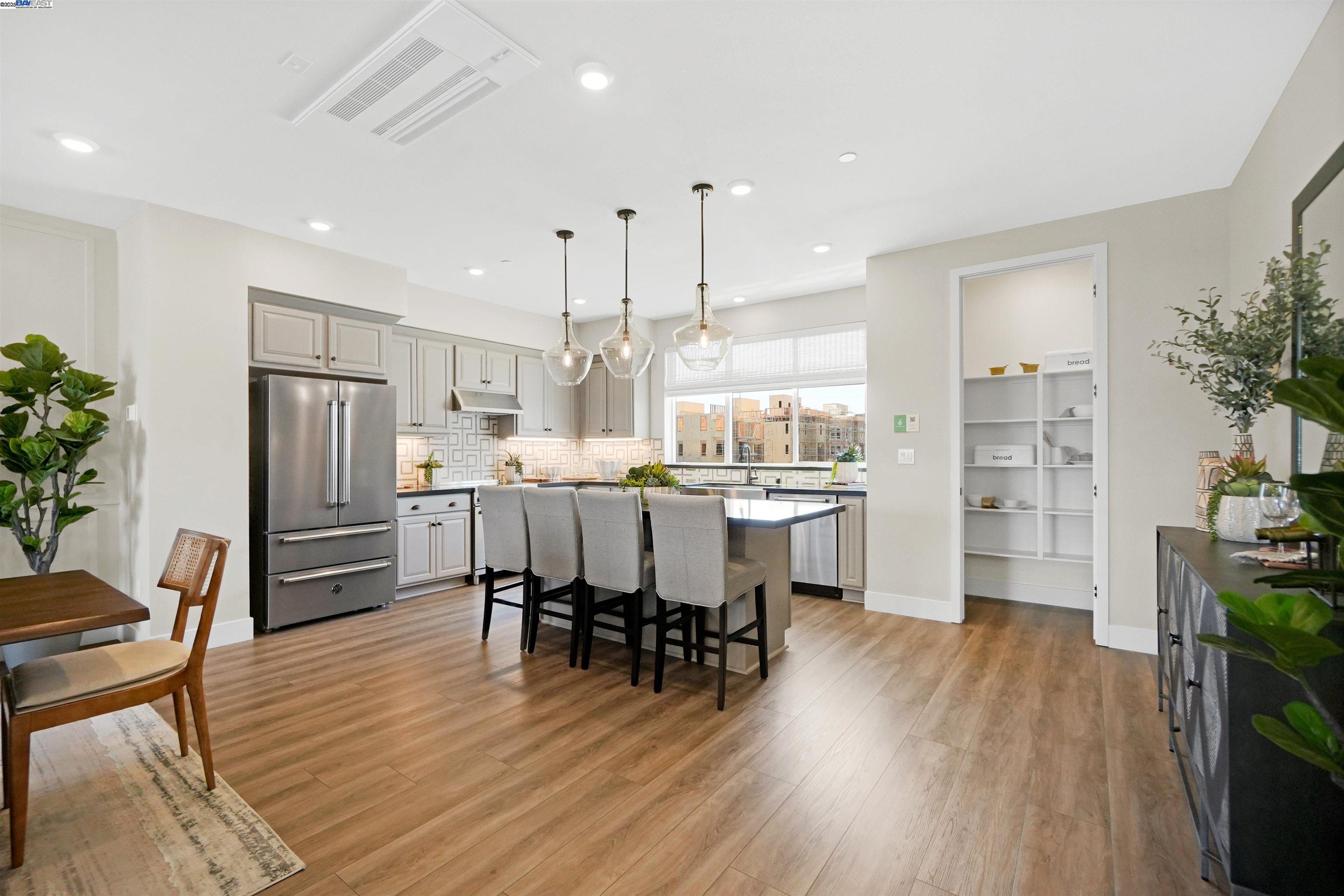 2256 Stanford Street Alameda, CA 94501 - Photo 10 of 60 a kitchen with a dining table chairs refrigerator and cabinets