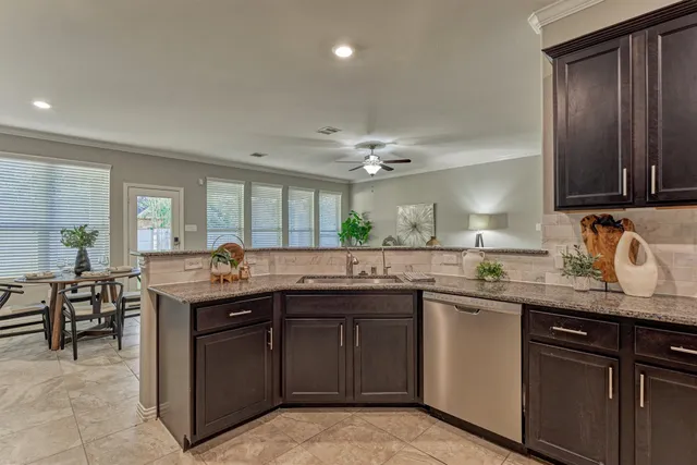 a kitchen with stainless steel appliances granite countertop a refrigerator stove and sink