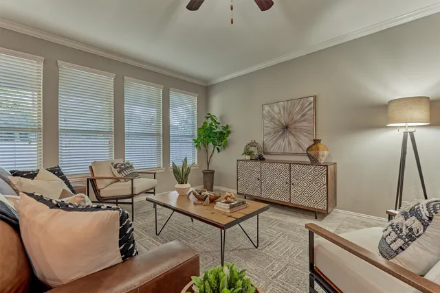a bedroom with a bed a chandelier and a dresser