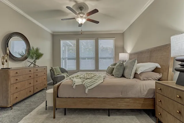 a en suite bathroom with a granite countertop sink a toilet and a mirror