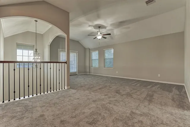 a view of a livingroom with a ceiling fan window and a ceiling fan