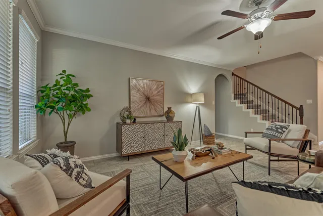 a living room with furniture and a potted plant