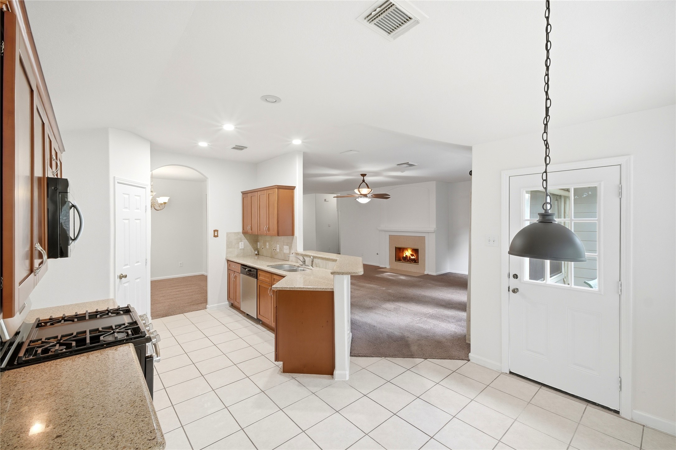 5411 Gate Canyon Court Spring, TX 77373 - Photo 13 of 33 a kitchen with stainless steel appliances kitchen island granite countertop a refrigerator and a stove top oven