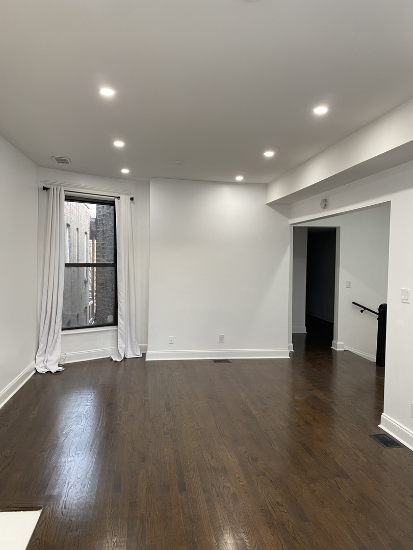 4813 South Prairie Avenue Chicago, IL 60615 - Photo 12 of 27 an empty room with wooden floor and closet