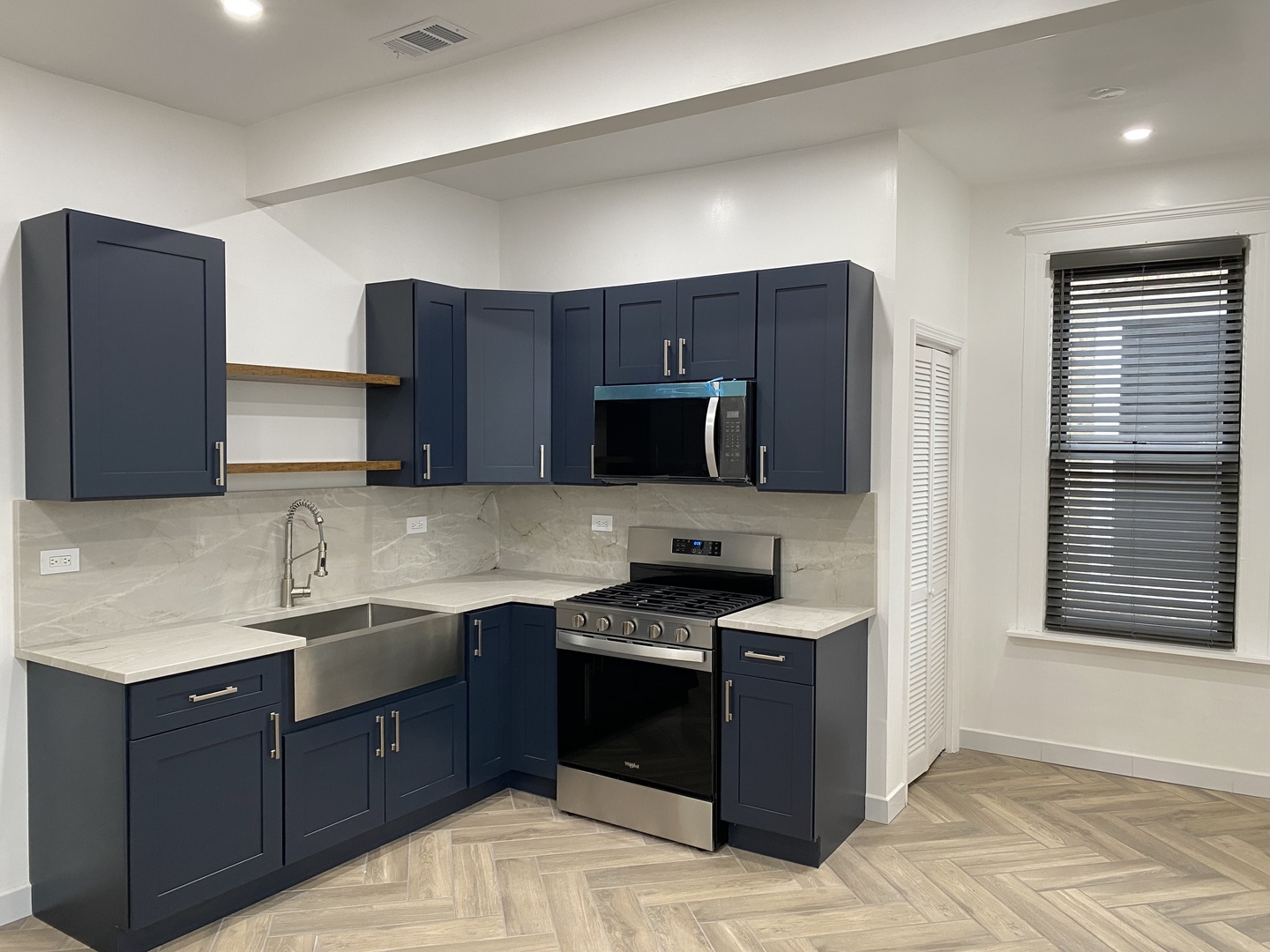 4813 South Prairie Avenue Chicago, IL 60615 - Photo 14 of 27 a kitchen with stainless steel appliances granite countertop a stove a sink and a microwave