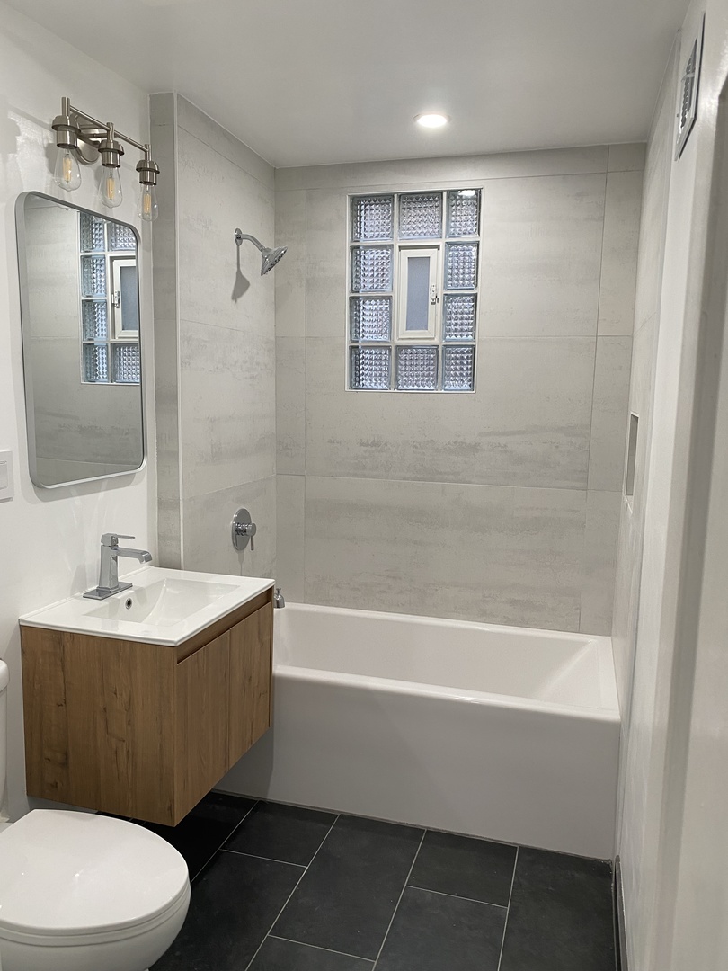 4813 South Prairie Avenue Chicago, IL 60615 - Photo 16 of 27 a bathroom with a sink a toilet and shower