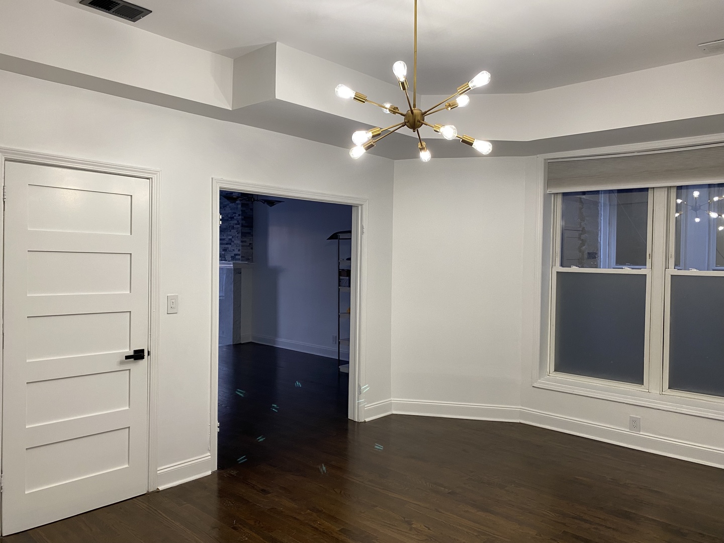 4813 South Prairie Avenue Chicago, IL 60615 - Photo 18 of 27 a view of an empty room with wooden floor and a window
