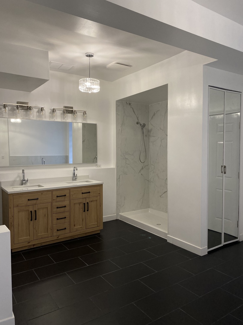 4813 South Prairie Avenue Chicago, IL 60615 - Photo 19 of 27 a bathroom with a double vanity sink and mirror