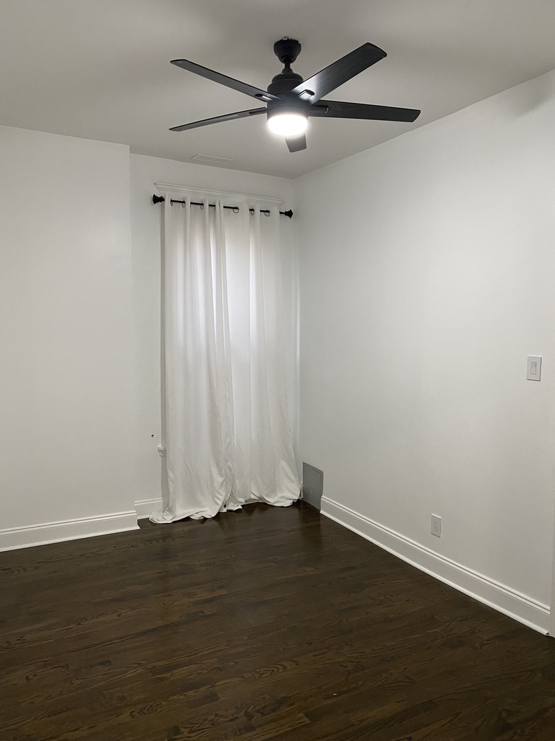 4813 South Prairie Avenue Chicago, IL 60615 - Photo 22 of 27 a view of an empty room with wooden floor