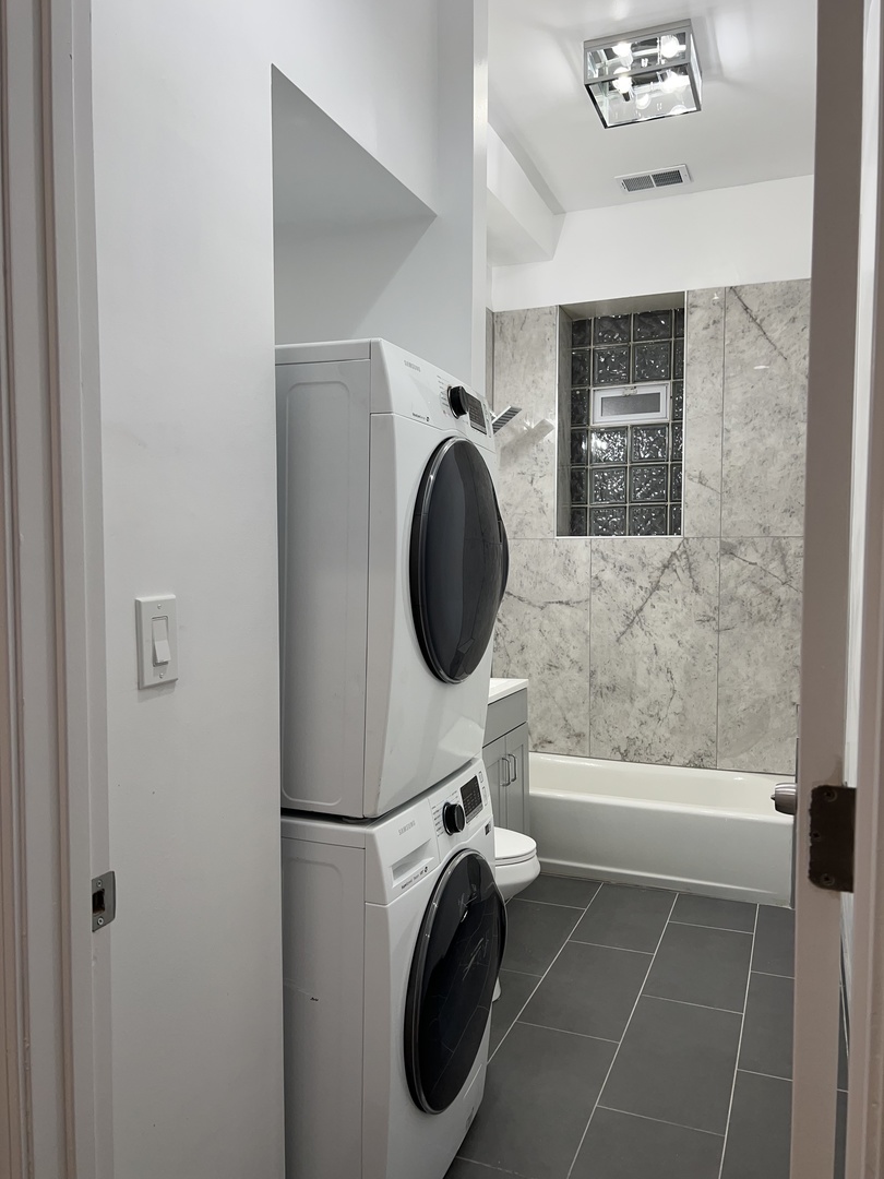 4813 South Prairie Avenue Chicago, IL 60615 - Photo 6 of 27 a bathroom with a sink a mirror and bathtub
