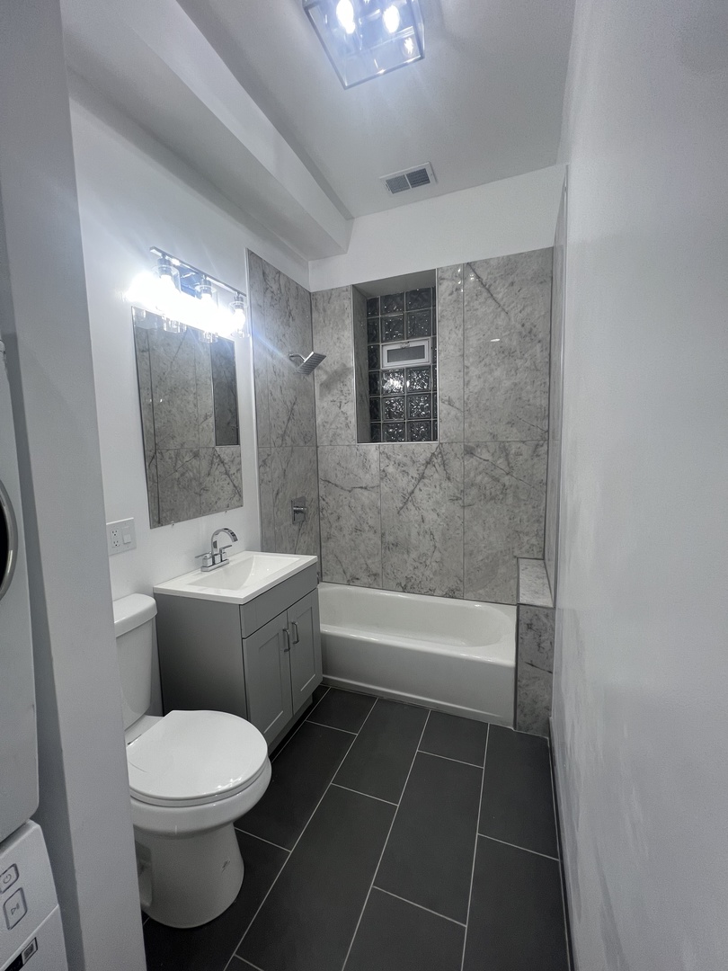 4813 South Prairie Avenue Chicago, IL 60615 - Photo 7 of 27 a bathroom with a toilet a sink and bathtub