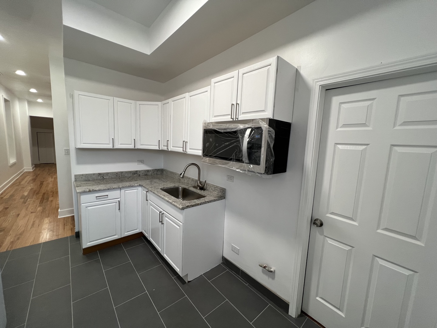 4813 South Prairie Avenue Chicago, IL 60615 - Photo 9 of 27 a kitchen with a sink a stove and cabinets