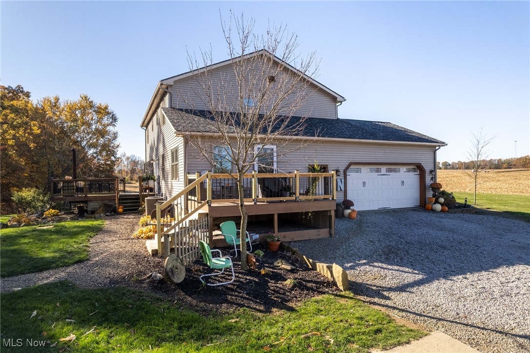 11827 Stratton Road West Salem, OH 44287 - Photo 6 of 47 View of front facade with a wooden deck, driveway, a front yard, and an attached garage