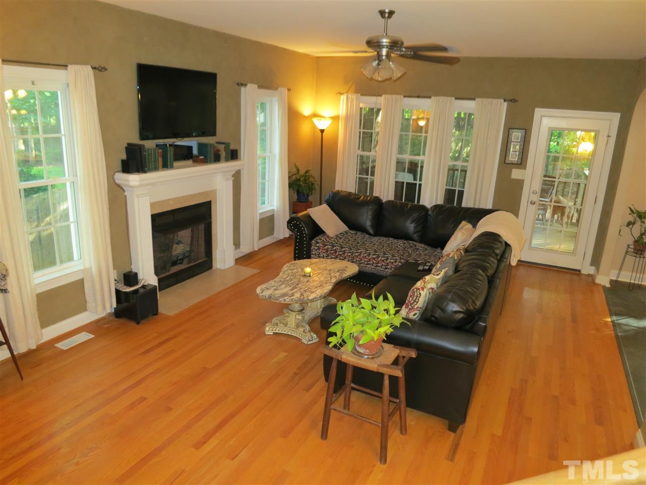 1328 Taylor Farm Road Raleigh, NC 27603 - Photo 3 of 24 a living room with furniture fireplace and flat screen tv