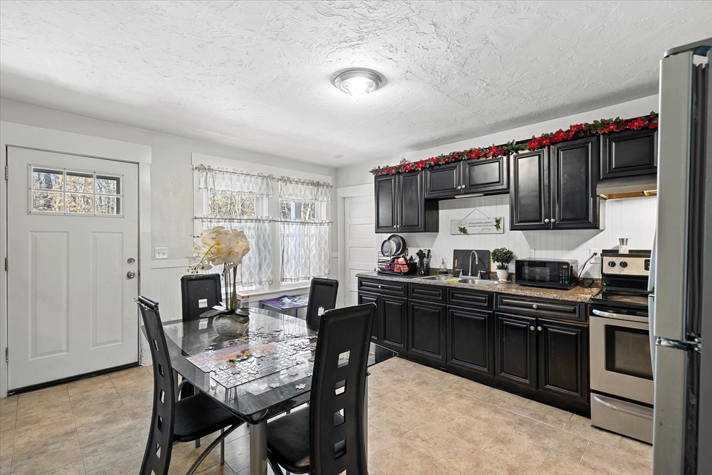 40 Sturbridge Road Charlton, MA 01507 - Photo 9 of 21 a kitchen with granite countertop a sink cabinets and stainless steel appliances