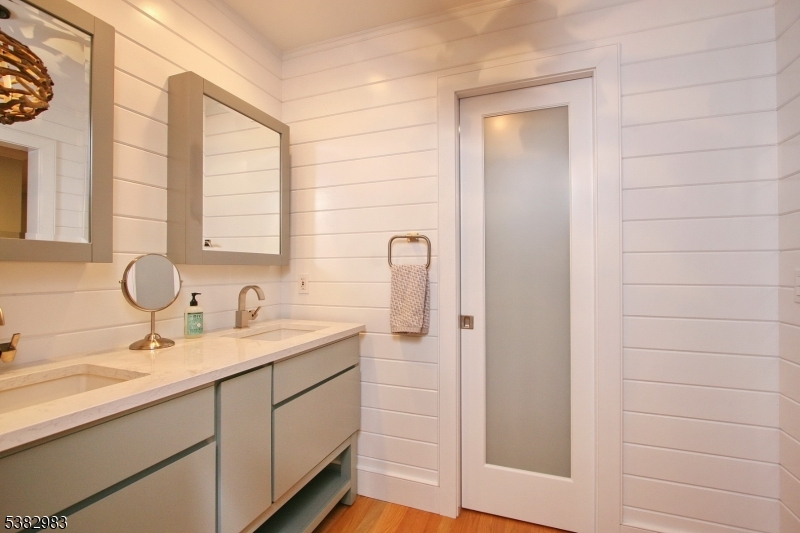 107 Lake End Road Newfoundland, NJ 07435 - Photo 16 of 23 a bathroom with a double vanity sink and mirror