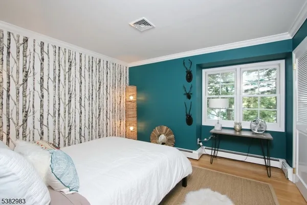 a bedroom with a bed chair and a window