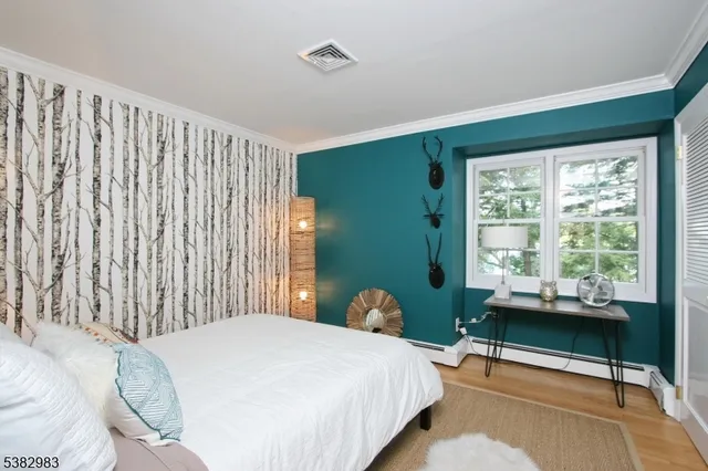 a bedroom with a bed chair and a window