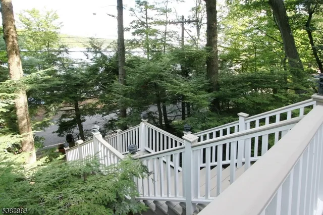 a view of balcony with wooden fence and trees