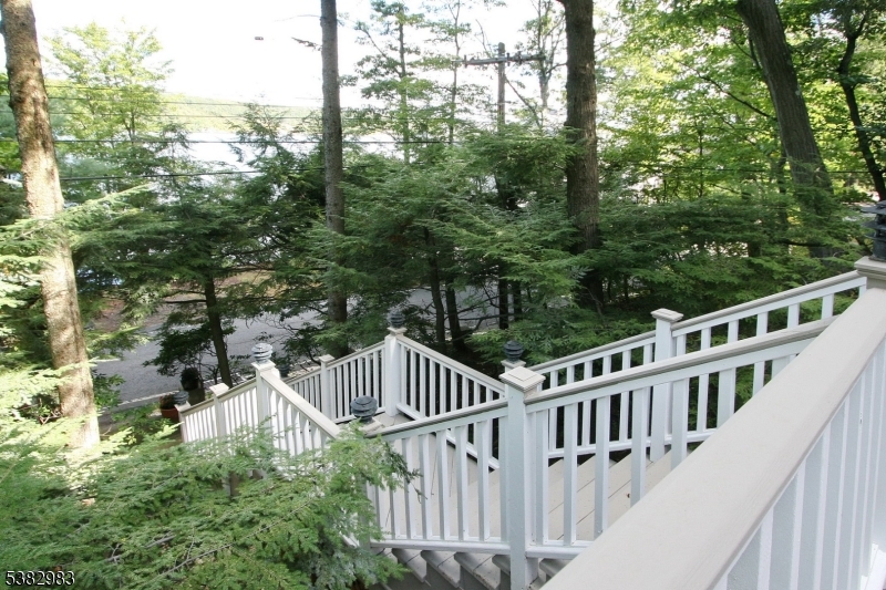 107 Lake End Road Newfoundland, NJ 07435 - Photo 3 of 23 a view of balcony with wooden fence and trees