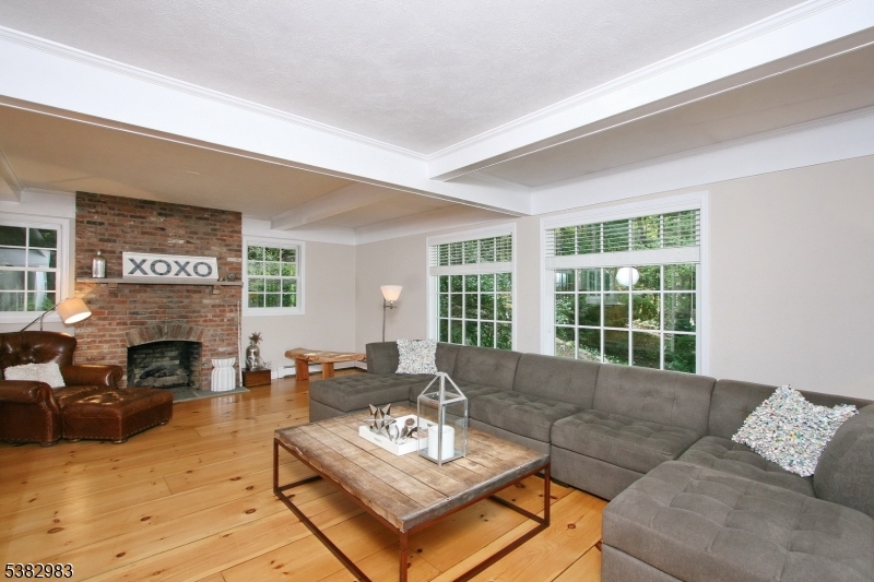 107 Lake End Road Newfoundland, NJ 07435 - Photo 8 of 23 a living room with furniture fireplace and a large window