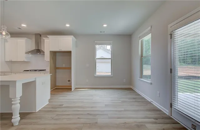 a view of kitchen with wooden floor and electronic appliances