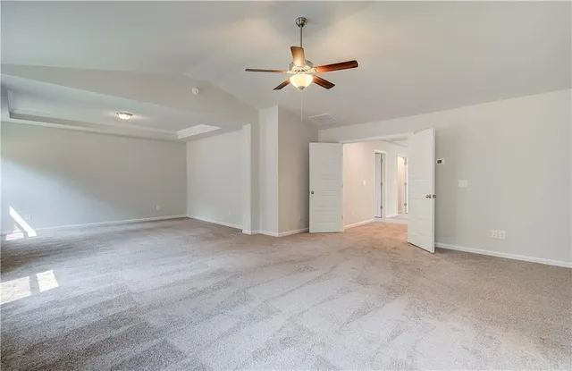 a view of an empty room with a ceiling fan