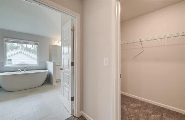 a bathroom with a bathtub and window