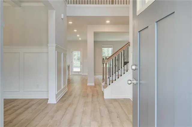 a view of a hallway with wooden floor and staircase