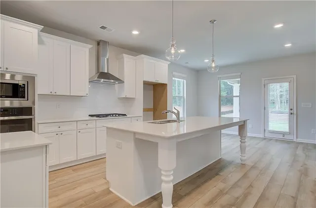 a large kitchen with stainless steel appliances kitchen island a large island in the center