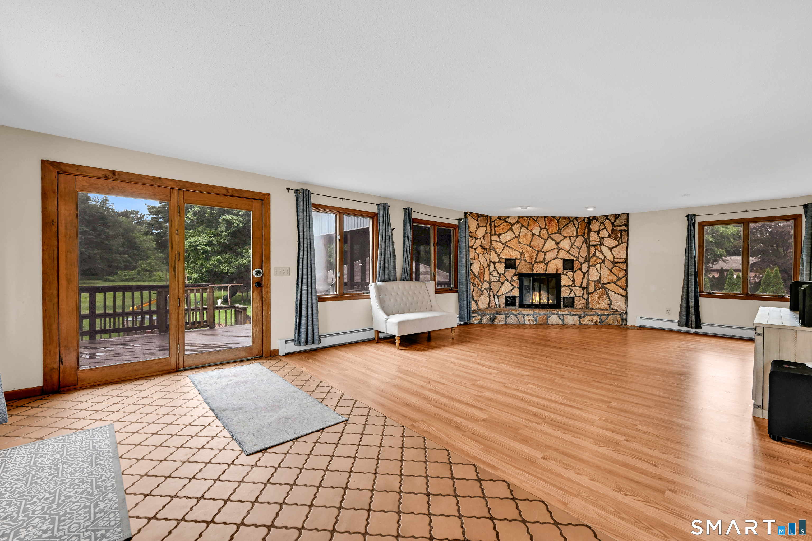 295 Wolcott Hill Road Wethersfield, CT 06109 - Photo 16 of 40 HUGE addition, added in 1980, adds this massive usable living room with sliders to a wonderful exterior living space, tiered deck with screen porch and .8 acres.
