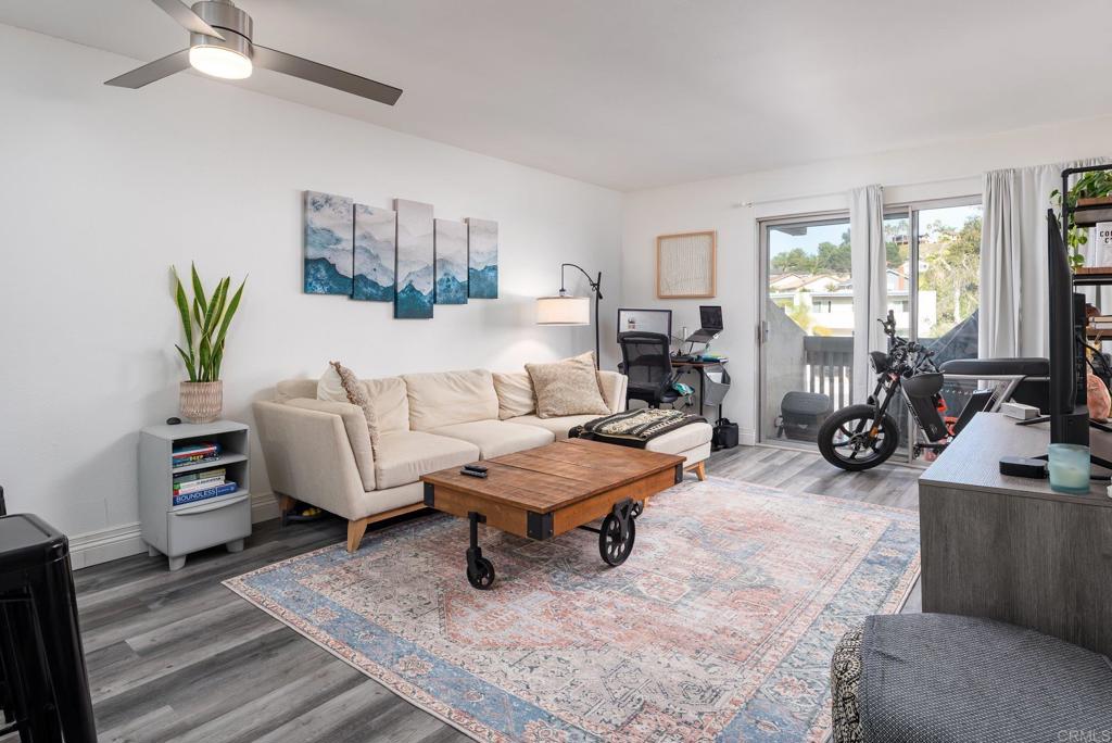 a living room with furniture rug and window