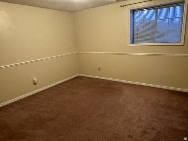 655 North 8th East Preston, ID 83263 - Photo 21 of 32 Spare room with dark carpet and baseboards